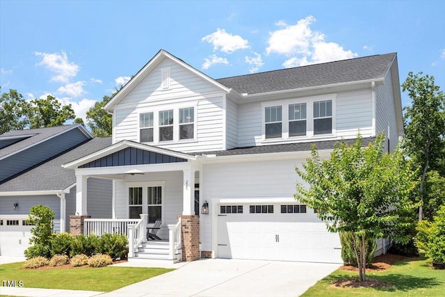 223 Chauncey Cir, Chapel Hill, NC 27516 - craftsman house featuring a porch, driveway, an attached garage, and board and batten siding