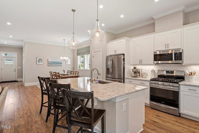 223 Chauncey Cir, Chapel Hill, NC 27516 - kitchen with appliances with stainless steel finishes, plenty of natural light, crown molding, recessed lighting, and a center island with sink