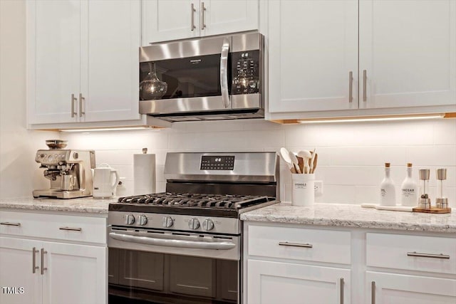223 Chauncey Cir, Chapel Hill, NC 27516 - kitchen featuring stainless steel appliances, backsplash, white cabinets, and light stone counters