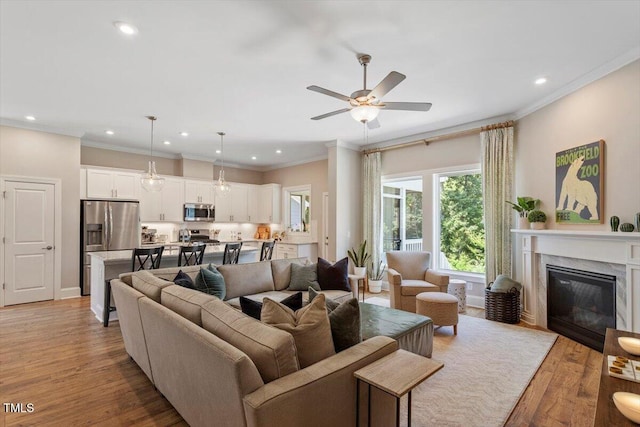 223 Chauncey Cir, Chapel Hill, NC 27516 - living room with crown molding, a ceiling fan, light wood-style flooring, recessed lighting, and a fireplace