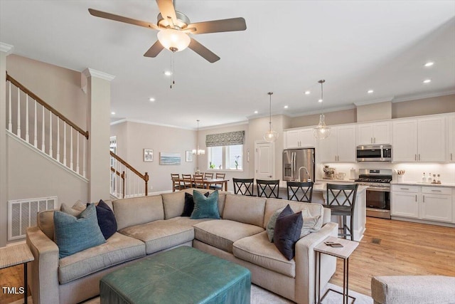 223 Chauncey Cir, Chapel Hill, NC 27516 - living area with a ceiling fan, stairs, recessed lighting, light wood-style flooring, and crown molding