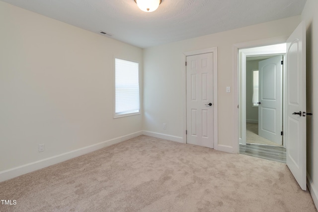 400 Minchew St SE, Wilson, NC 27893 - unfurnished bedroom featuring carpet flooring and baseboards