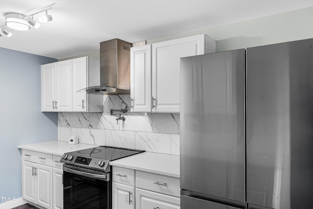 6005 Lake Wheeler Rd, Raleigh, NC 27603 - kitchen featuring appliances with stainless steel finishes, wall chimney range hood, decorative backsplash, and white cabinets