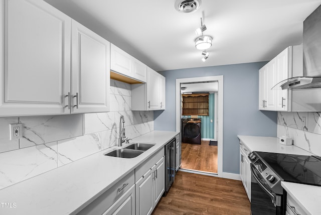 6005 Lake Wheeler Rd, Raleigh, NC 27603 - kitchen with wall chimney range hood, black electric range, light countertops, white cabinets, and decorative backsplash