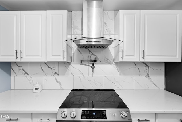 6005 Lake Wheeler Rd, Raleigh, NC 27603 - kitchen featuring wall chimney exhaust hood, stainless steel electric stove, light countertops, and white cabinets