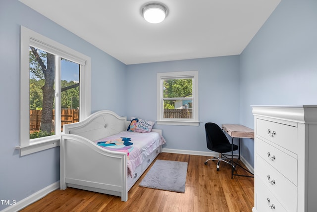 6005 Lake Wheeler Rd, Raleigh, NC 27603 - bedroom featuring multiple windows, wood finished floors, and a desk