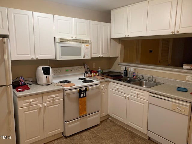 929 Morreene Rd Unit B-24, Durham, NC 27705 - kitchen with white appliances, white cabinetry, and light countertops