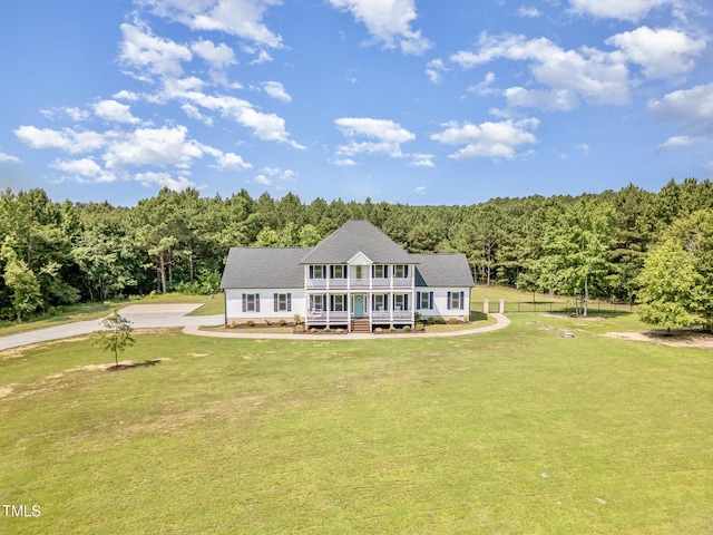407 Kadir Womble Dr, New Hill, NC 27562 - colonial-style house with a view of trees, covered porch, and a balcony