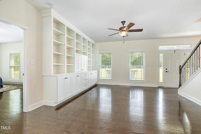 407 Kadir Womble Dr, New Hill, NC 27562 - unfurnished living room featuring stairs, dark wood finished floors, and ceiling fan