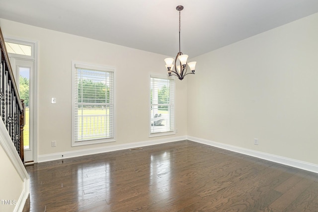 407 Kadir Womble Dr, New Hill, NC 27562 - unfurnished room featuring dark wood-style floors, plenty of natural light, and a chandelier