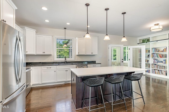 407 Kadir Womble Dr, New Hill, NC 27562 - kitchen featuring stainless steel appliances, a kitchen breakfast bar, dark wood finished floors, white cabinets, and recessed lighting