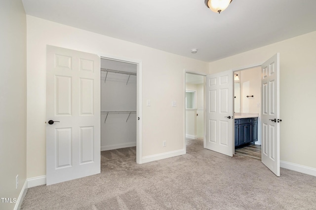 407 Kadir Womble Dr, New Hill, NC 27562 - unfurnished bedroom featuring light carpet, a closet, ensuite bathroom, and a spacious closet