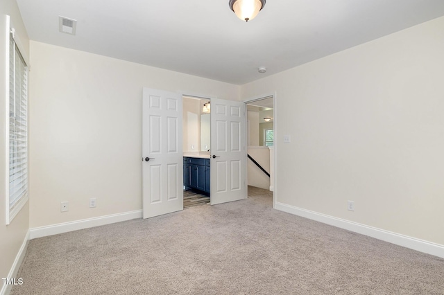 407 Kadir Womble Dr, New Hill, NC 27562 - unfurnished bedroom featuring light colored carpet