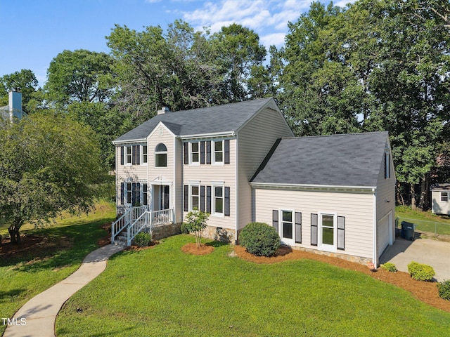 1524 Wedgewood Dr, Graham, NC 27253 - colonial-style house featuring a front yard, roof with shingles, and a chimney