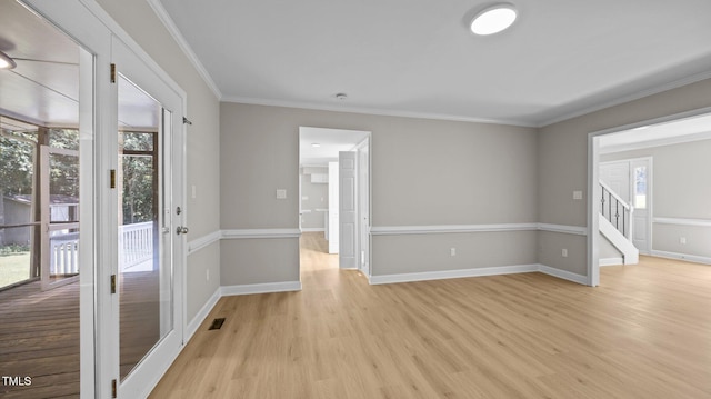 1524 Wedgewood Dr, Graham, NC 27253 - empty room with light wood finished floors, ornamental molding, and stairs