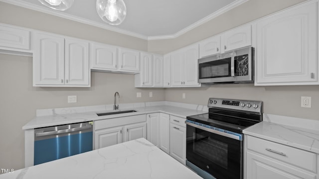 1524 Wedgewood Dr, Graham, NC 27253 - kitchen with appliances with stainless steel finishes, light stone counters, white cabinets, and ornamental molding