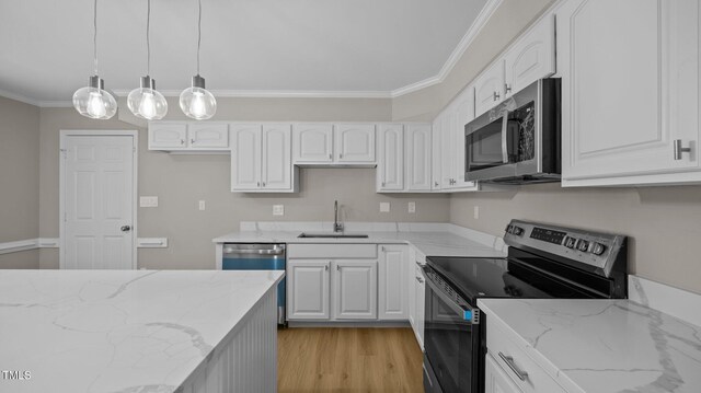 1524 Wedgewood Dr, Graham, NC 27253 - kitchen with appliances with stainless steel finishes, ornamental molding, light stone countertops, and white cabinetry