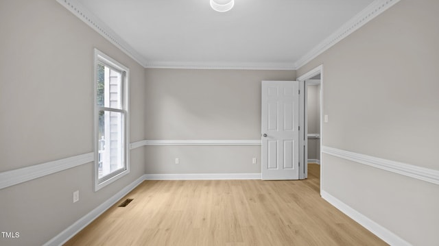 1524 Wedgewood Dr, Graham, NC 27253 - empty room featuring plenty of natural light, light wood-style flooring, and ornamental molding