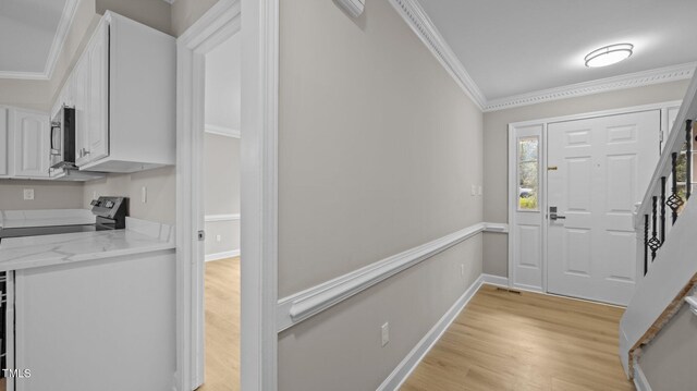 1524 Wedgewood Dr, Graham, NC 27253 - foyer entrance with crown molding, light wood finished floors, and stairs