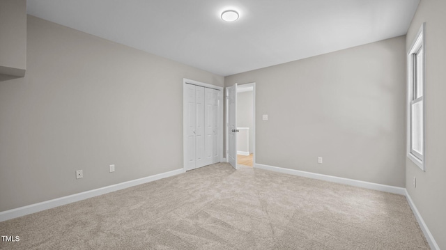 1524 Wedgewood Dr, Graham, NC 27253 - unfurnished bedroom featuring light carpet, multiple windows, and a closet