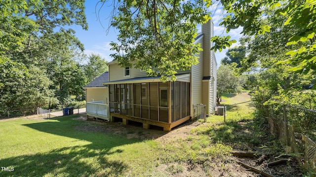 1524 Wedgewood Dr, Graham, NC 27253 - back of property with a sunroom, a shingled roof, a fenced backyard, and a chimney