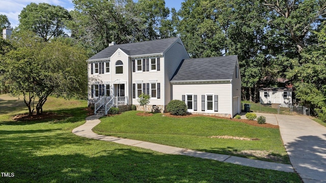 1524 Wedgewood Dr, Graham, NC 27253 - colonial house with a front yard, driveway, a shingled roof, and a chimney