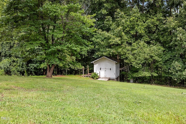 1105 Fontaine Rd, Roxboro, NC 27574 - view of green lawn with a storage unit and a wooded view