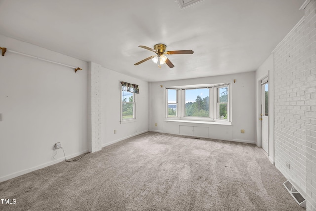 1105 Fontaine Rd, Roxboro, NC 27574 - spare room with carpet floors, a ceiling fan, and brick wall