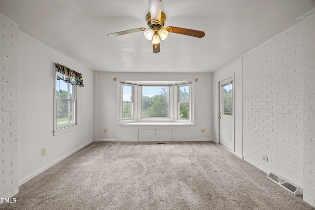 1105 Fontaine Rd, Roxboro, NC 27574 - carpeted empty room with brick wall and a ceiling fan