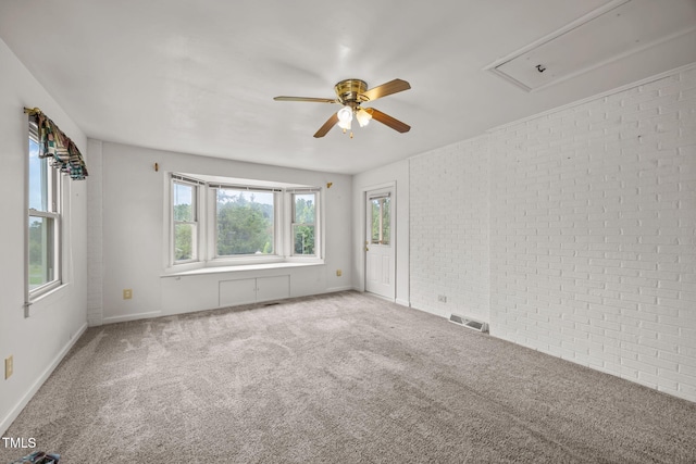 1105 Fontaine Rd, Roxboro, NC 27574 - unfurnished room featuring a ceiling fan, attic access, carpet, and brick wall
