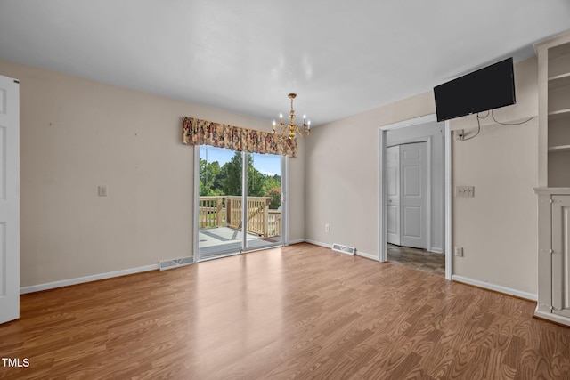 1105 Fontaine Rd, Roxboro, NC 27574 - empty room with a chandelier and wood finished floors