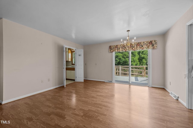 1105 Fontaine Rd, Roxboro, NC 27574 - unfurnished room with wood finished floors and a chandelier