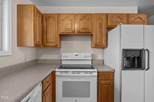 1105 Fontaine Rd, Roxboro, NC 27574 - kitchen featuring white appliances, light countertops, and brown cabinets