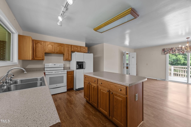 1105 Fontaine Rd, Roxboro, NC 27574 - kitchen featuring white appliances, dark wood finished floors, a kitchen island, light countertops, and brown cabinets