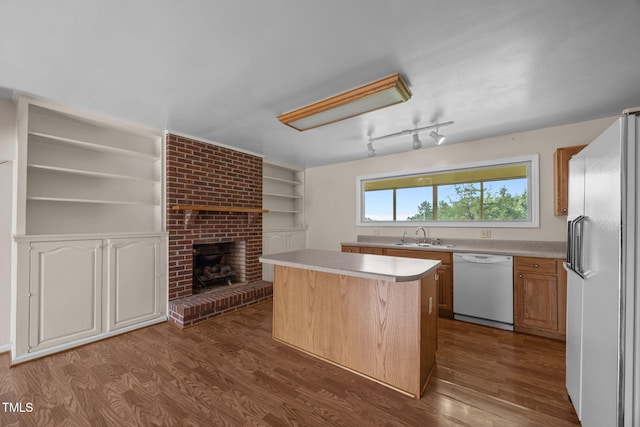 1105 Fontaine Rd, Roxboro, NC 27574 - kitchen with white appliances, a kitchen island, dark wood-style floors, light countertops, and built in features