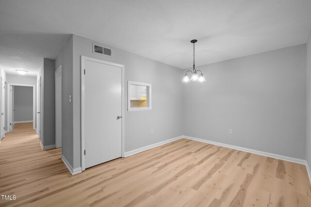 500 Umstead Dr Unit 103E, Chapel Hill, NC 27516 - unfurnished dining area with light wood-style floors and a chandelier
