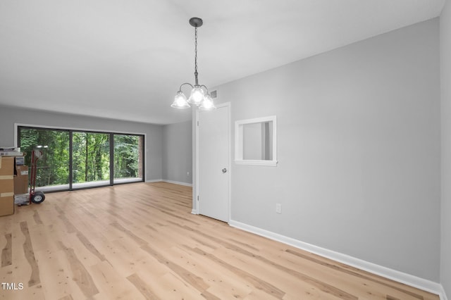 500 Umstead Dr Unit 103E, Chapel Hill, NC 27516 - unfurnished living room featuring wood finished floors and a chandelier