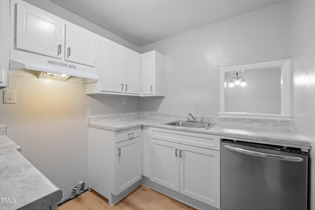 500 Umstead Dr Unit 103E, Chapel Hill, NC 27516 - kitchen with dishwasher, under cabinet range hood, light countertops, white cabinetry, and light wood-style flooring
