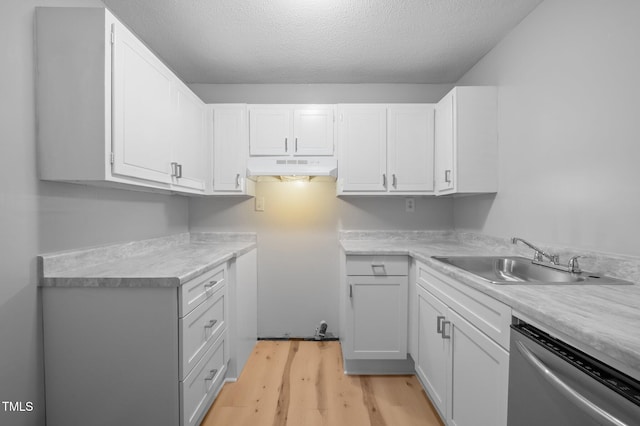 500 Umstead Dr Unit 103E, Chapel Hill, NC 27516 - kitchen with stainless steel dishwasher, light wood-style flooring, light countertops, white cabinets, and a textured ceiling