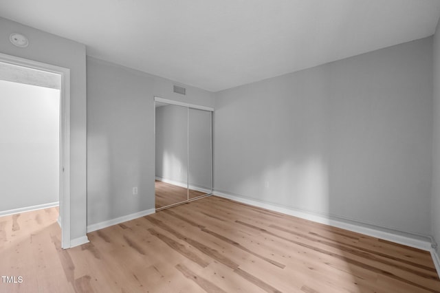 500 Umstead Dr Unit 103E, Chapel Hill, NC 27516 - unfurnished bedroom with wood finished floors and a closet