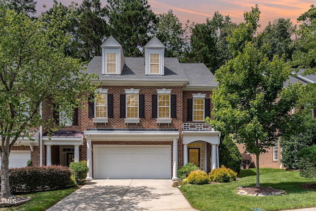 4060 Barton Park Pl, Raleigh, NC 27613 - colonial house with brick siding, concrete driveway, a garage, and a lawn