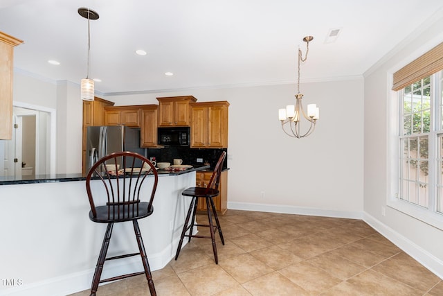 4060 Barton Park Pl, Raleigh, NC 27613 - kitchen with black microwave, stainless steel fridge with ice dispenser, crown molding, decorative backsplash, and a kitchen breakfast bar