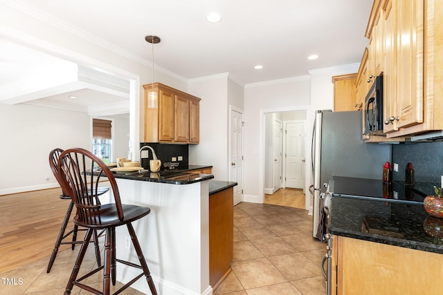 4060 Barton Park Pl, Raleigh, NC 27613 - kitchen with a kitchen bar, black microwave, light tile patterned flooring, a peninsula, and recessed lighting