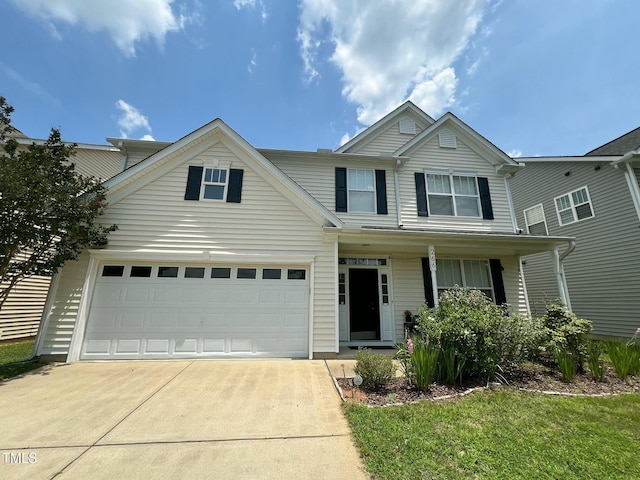 266 Stobhill Ln, Holly Springs, NC 27540 - traditional-style home featuring concrete driveway, an attached garage, and covered porch