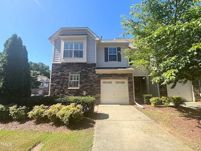 112 Salmon River Dr, Durham, NC 27705 - view of front of property featuring stone siding, concrete driveway, and an attached garage