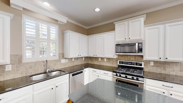 112 Salmon River Dr, Durham, NC 27705 - kitchen featuring appliances with stainless steel finishes, white cabinets, backsplash, dark stone counters, and ornamental molding