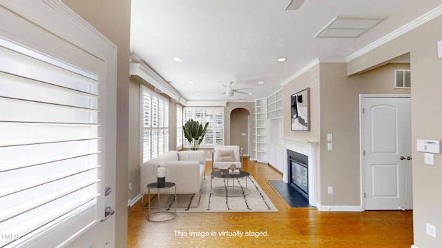 112 Salmon River Dr, Durham, NC 27705 - living area featuring built in features, a ceiling fan, wood finished floors, ornamental molding, and recessed lighting