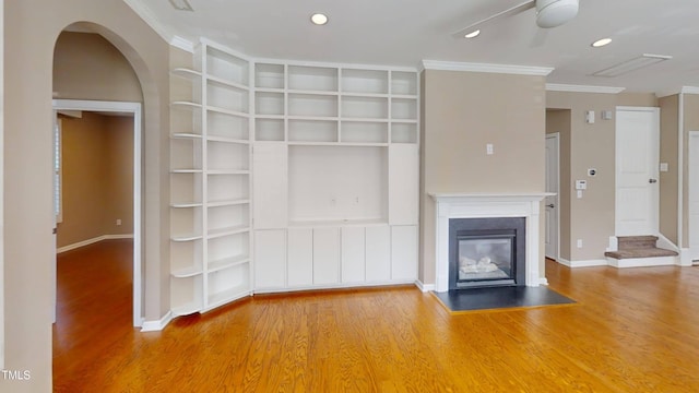 112 Salmon River Dr, Durham, NC 27705 - unfurnished living room featuring wood finished floors, built in features, ornamental molding, arched walkways, and recessed lighting