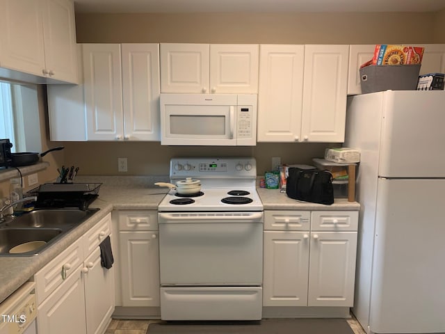 929 Morreene Rd Unit D-34, Durham, NC 27705 - kitchen with white appliances, white cabinetry, and light countertops