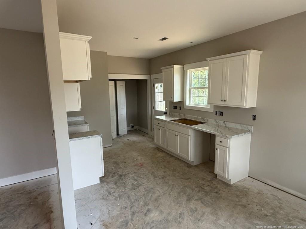 707 N Wilson Ave, Dunn, NC 28334 - kitchen with white cabinetry and light countertops